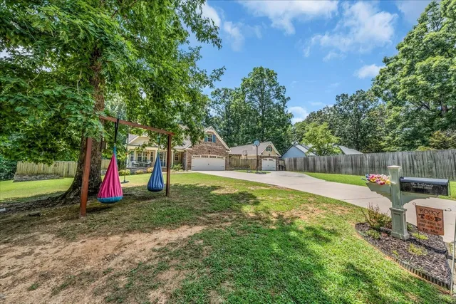 a view of a backyard with swimming pool