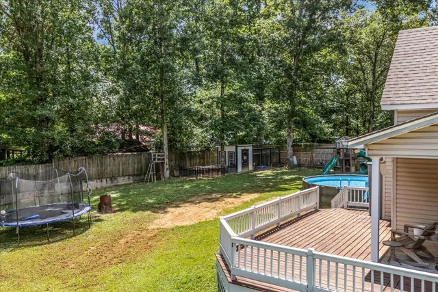 a view of a patio with a table chairs and a swimming pool