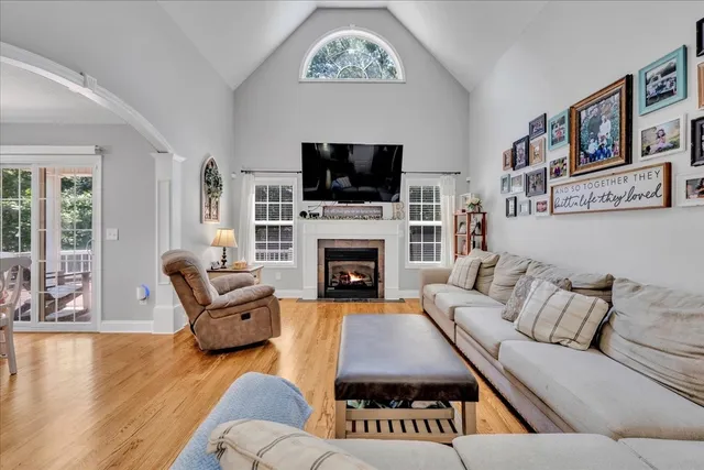 a living room with furniture fireplace and flat screen tv
