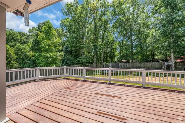 a view of balcony with wooden floor and fence