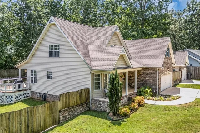 a view of an house with backyard space and swimming pool