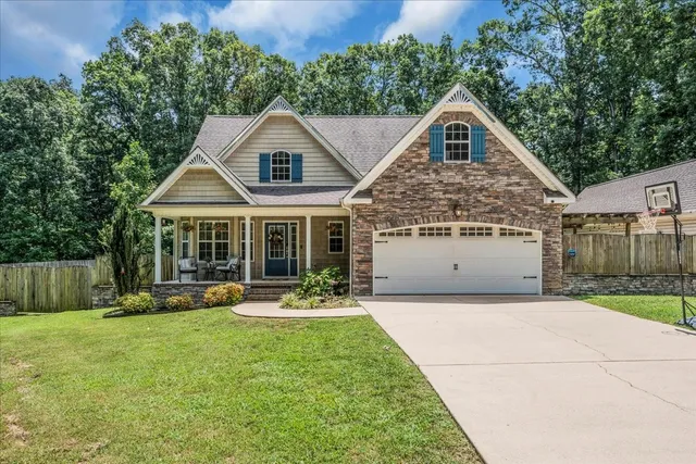 a front view of house with yard and green space