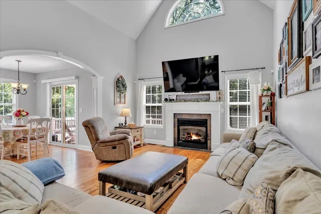 a living room with furniture fireplace and flat screen tv
