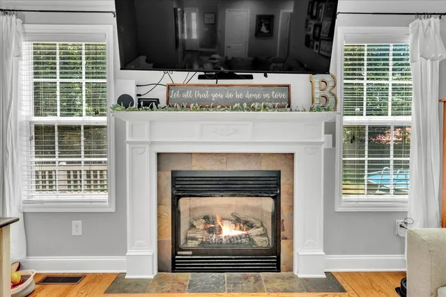 a living room with a fireplace and a large window