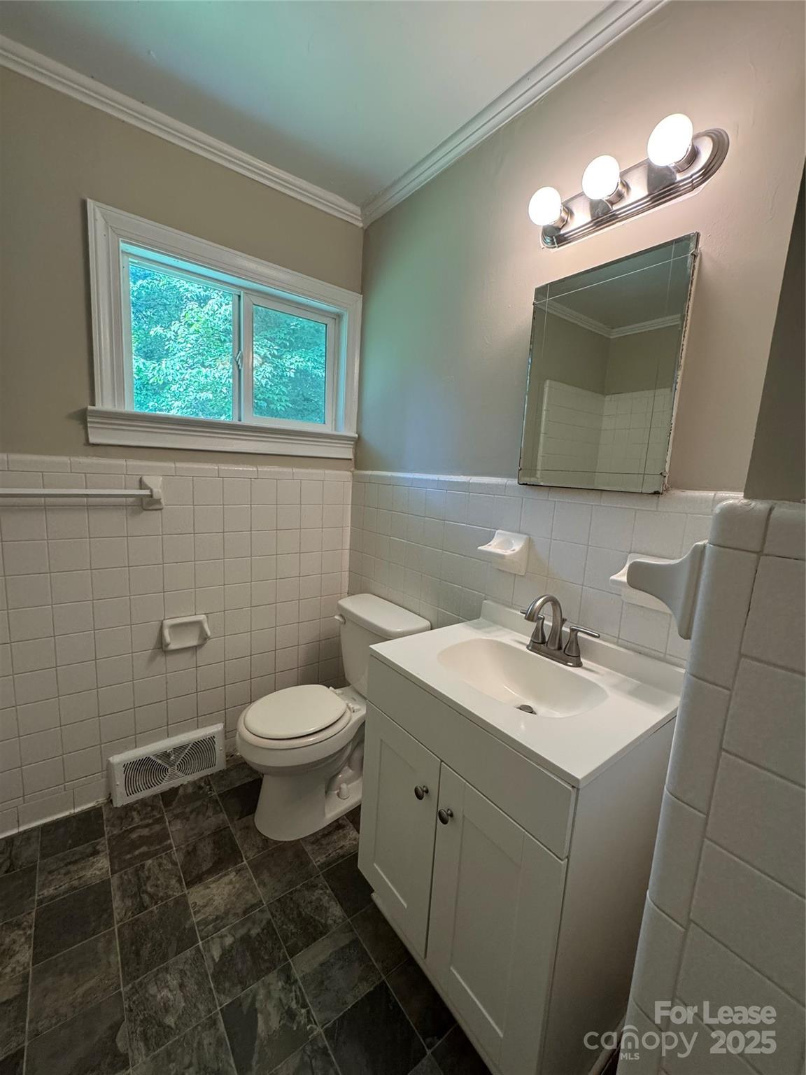 336 Crestside Drive Southeast Concord, NC 28025 - Photo 6 of 9 a bathroom with a toilet a sink a mirror a window and vanity
