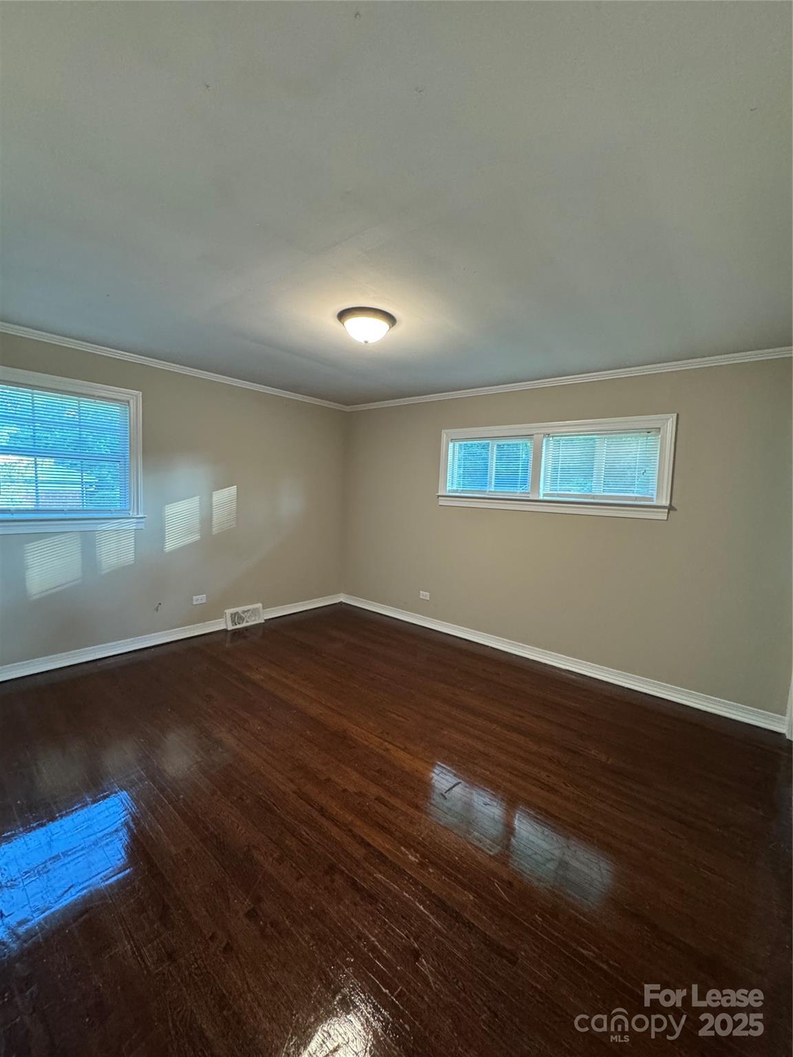 336 Crestside Drive Southeast Concord, NC 28025 - Photo 8 of 9 a view of an empty room with wooden floor and a window