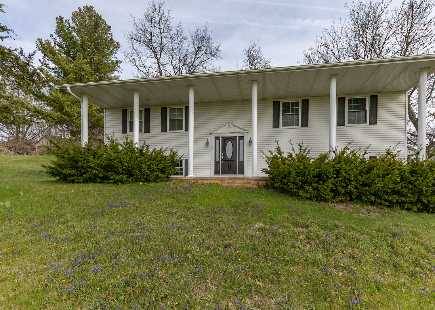 a front view of a house with garden