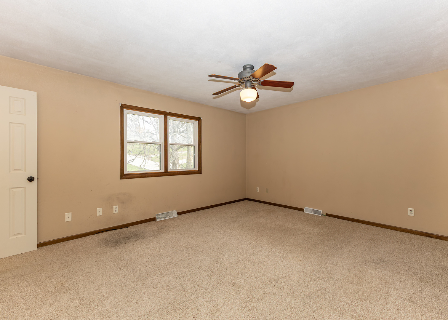 25 Oak Grove Road Geneseo, IL 61254 - Photo 11 of 22 an empty room with windows and ceiling fan