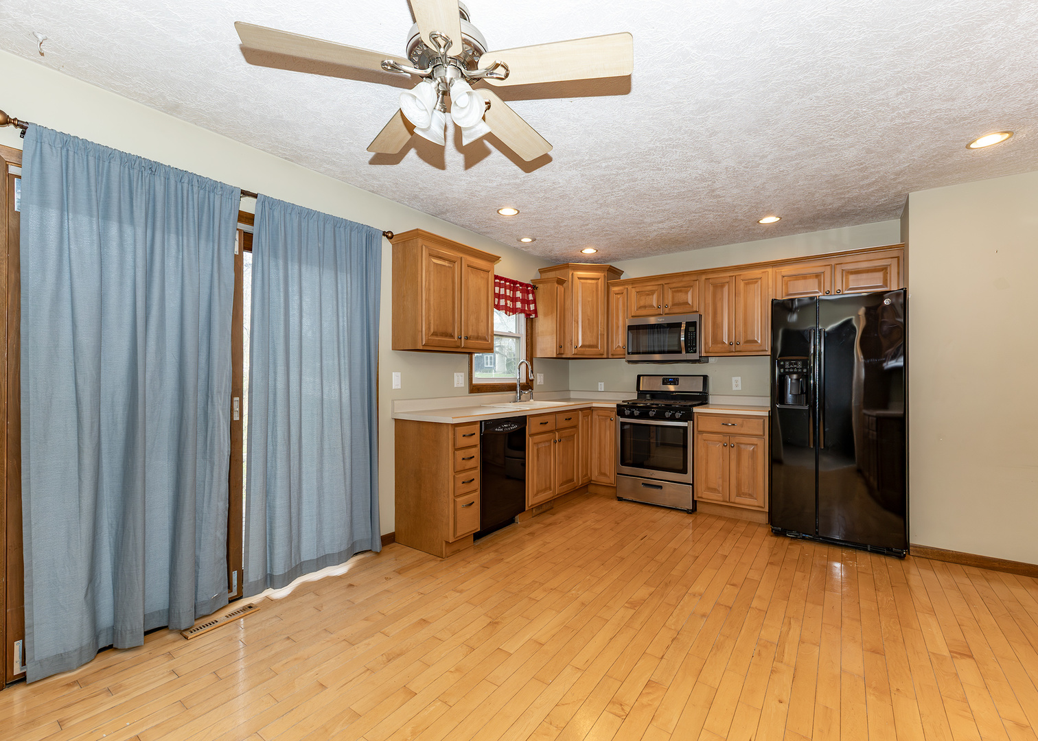 25 Oak Grove Road Geneseo, IL 61254 - Photo 5 of 22 a kitchen with stainless steel appliances granite countertop a refrigerator a stove top oven a sink dishwasher and wooden cabinets
