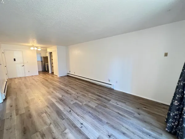 a view of a room with wooden floor