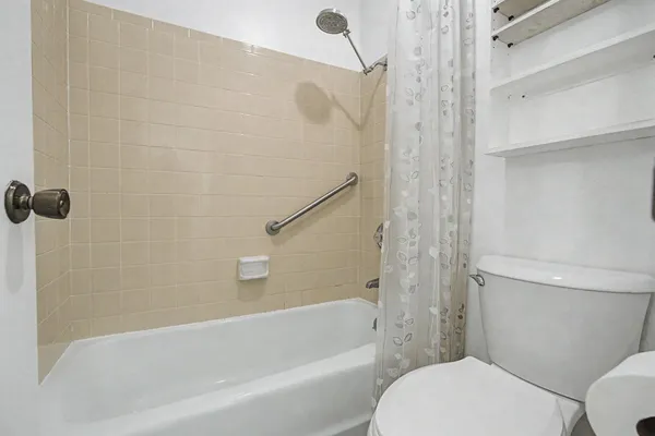 a bathroom with a bathtub and a toilet