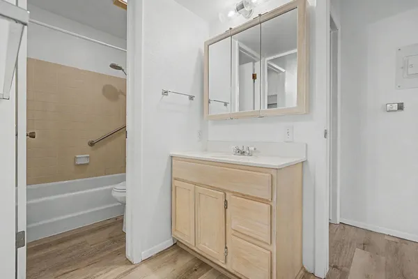 a bathroom with a sink a mirror and a shower