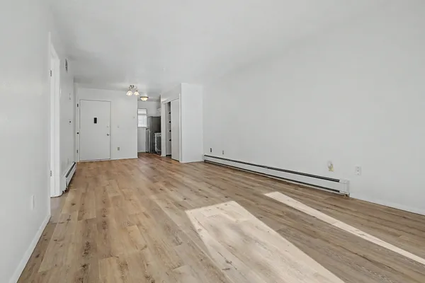a view of a room with wooden floor