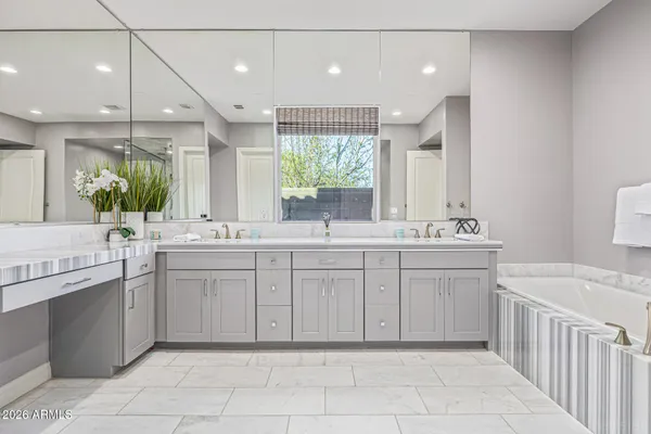 a spacious bedroom with a bed and a cabinets