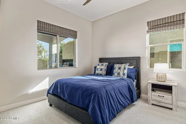 a bed room with a bed and a chair