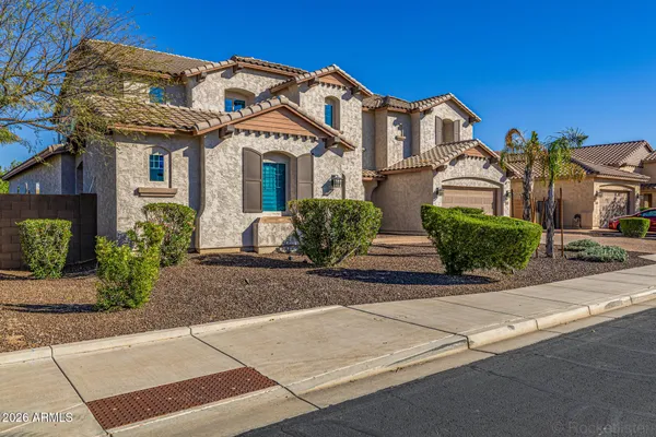 a view of a brick house with potted plants