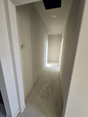 an empty room with closet and a bathroom