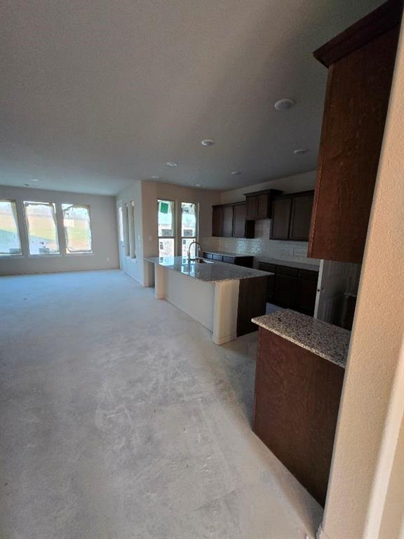 111 Hillview Trail Decatur, TX 76234 - Photo 10 of 20 a living room with stainless steel appliances a fireplace a flat screen tv and a window