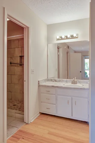 a bathroom with a double vanity sink and a mirror