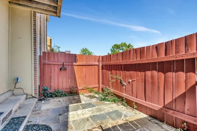 a view of a house with wooden fence