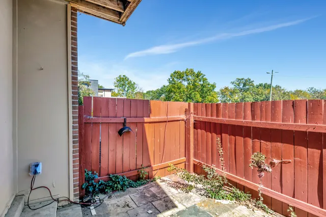 a view of small yard with wooden fence
