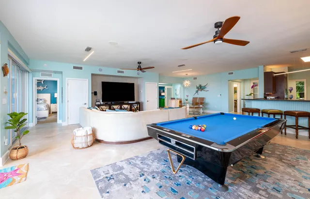 a living room with furniture flat screen tv and white walls
