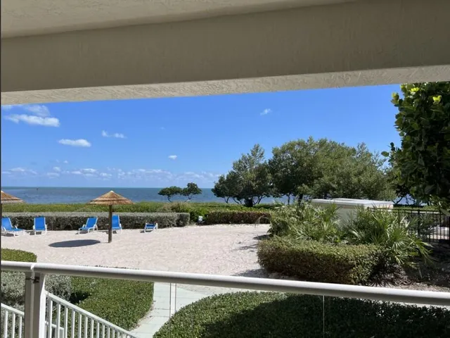 a bedroom with furniture and large windows