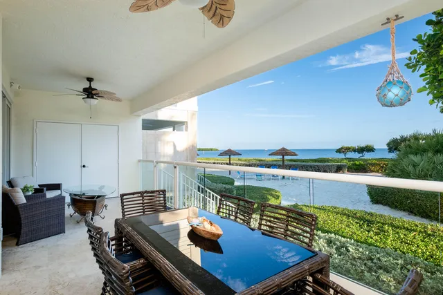 a living room with furniture and large windows