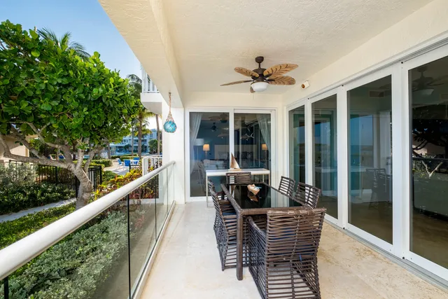 a bathroom with a granite countertop sink a mirror and tub