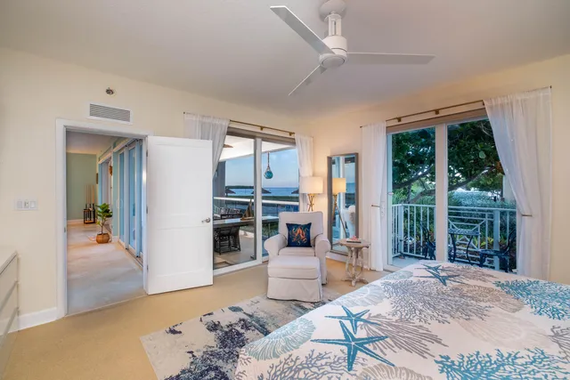 a bedroom with a bed and a flat tv screen on dresser
