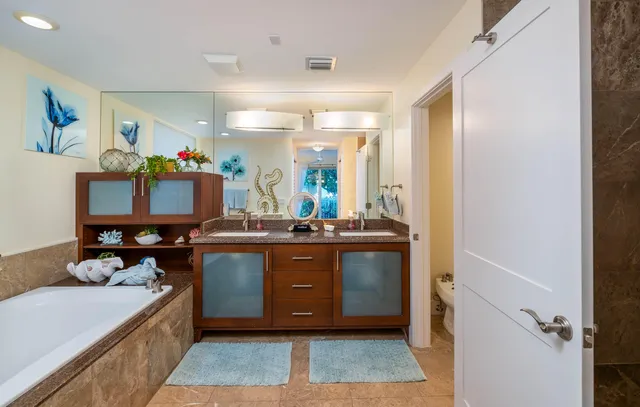 a view of a hallway with entryway and furniture