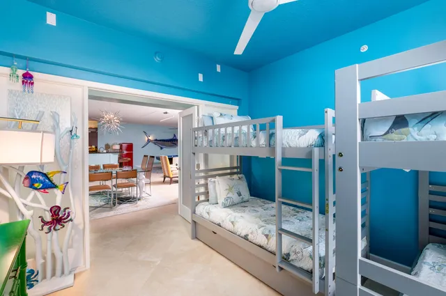 a living room with furniture a ceiling fan and a window