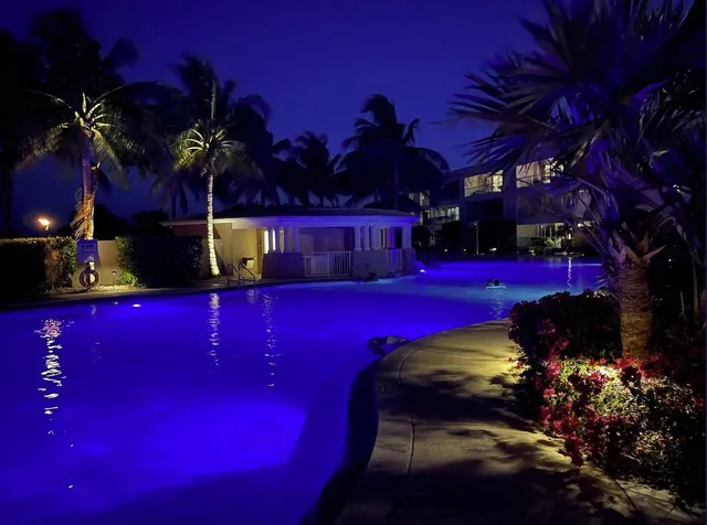 a view of swimming pool with outdoor seating and lake view