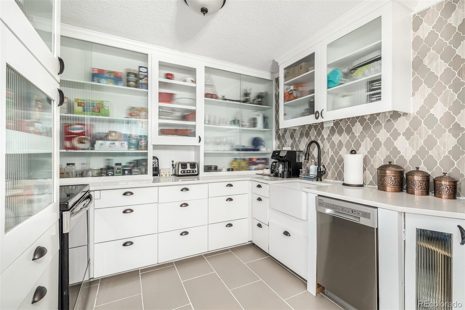 a kitchen with stainless steel appliances cabinets and a window
