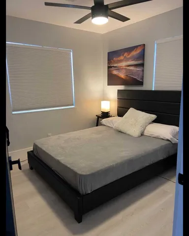 a bedroom with a bed and wall painting