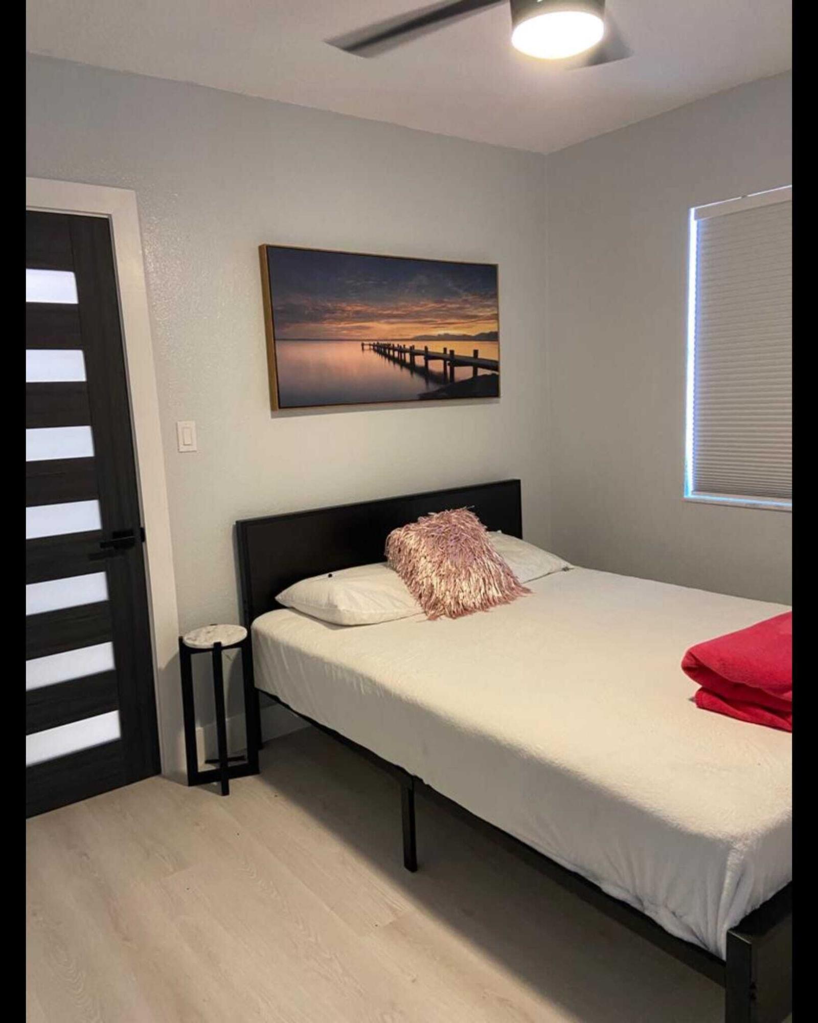 417 Southard Street, Unit A Key West, FL 33040 - Photo 6 of 8 a bedroom with a bed and a lamp on dresser