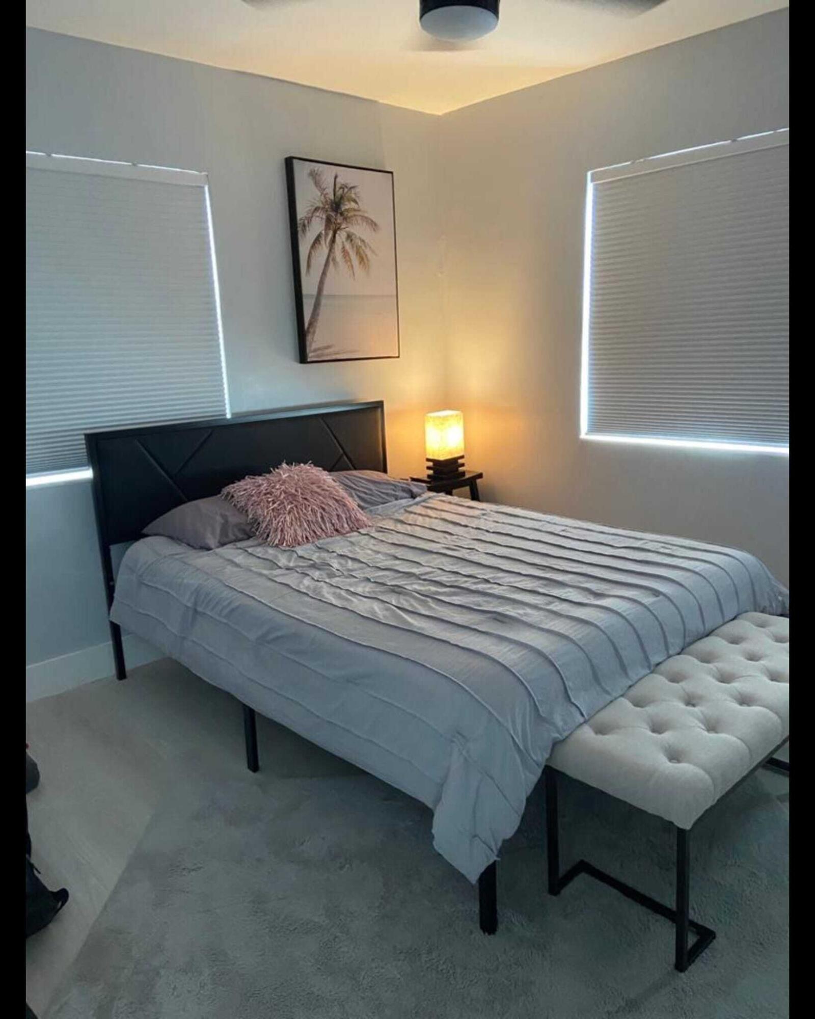 417 Southard Street, Unit A Key West, FL 33040 - Photo 7 of 8 a bedroom with a bed and a lamp on table