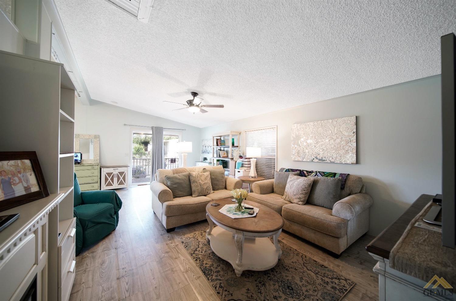 Undisclosed Address Bakersfield, CA 93308 - Photo 15 of 25 a living room with furniture and a flat screen tv
