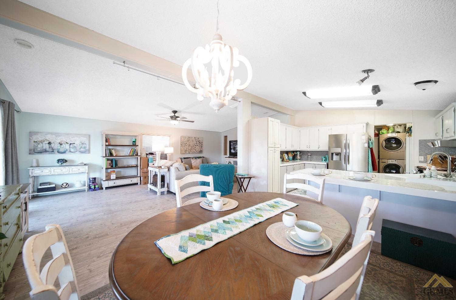 Undisclosed Address Bakersfield, CA 93308 - Photo 16 of 25 a dining room with wooden floor and large windows