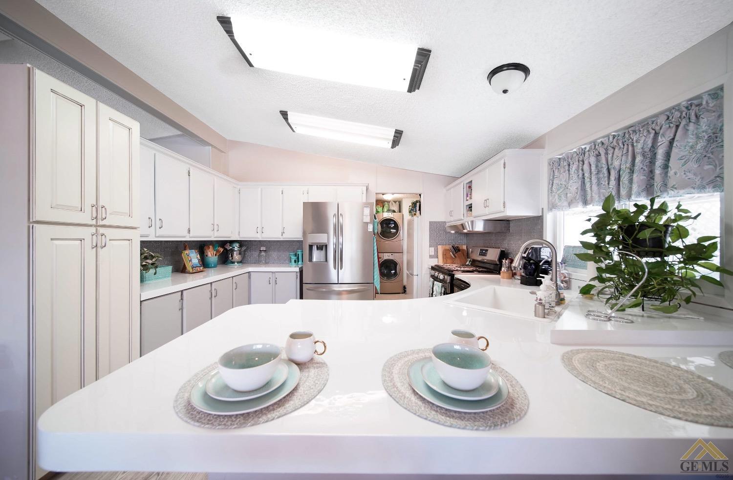 Undisclosed Address Bakersfield, CA 93308 - Photo 18 of 25 a kitchen with stainless steel appliances kitchen island granite countertop a table and chairs in it