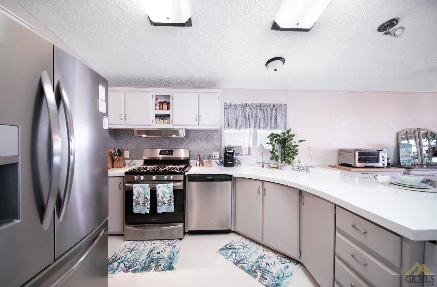 Undisclosed Address Bakersfield, CA 93308 - Photo 19 of 25 a kitchen with stainless steel appliances granite countertop a sink stove and refrigerator