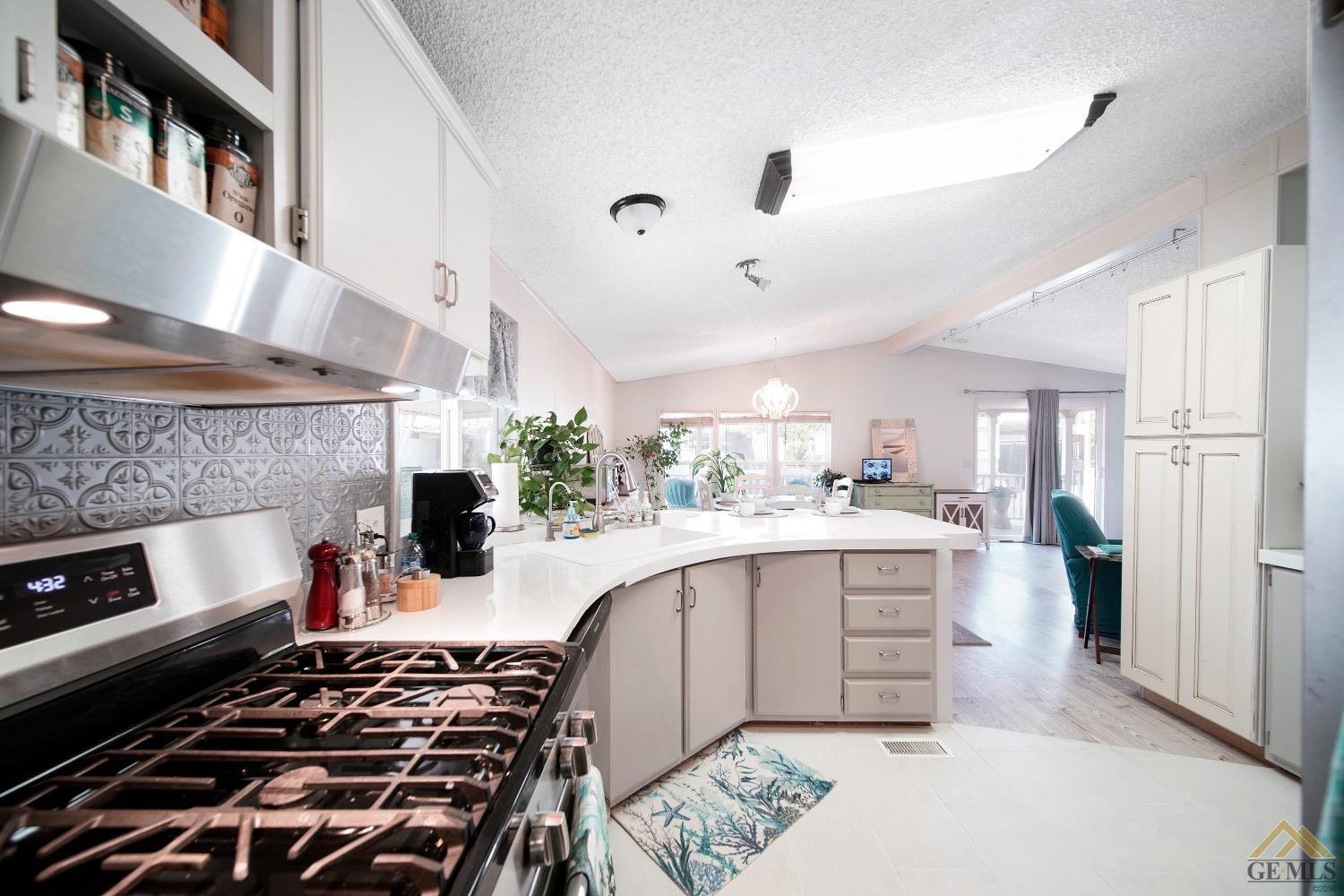 Undisclosed Address Bakersfield, CA 93308 - Photo 21 of 25 a kitchen with a stove and a refrigerator