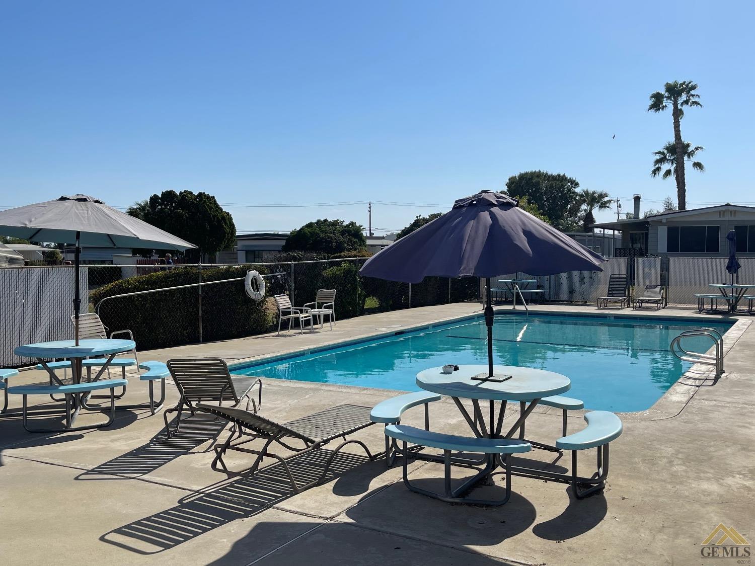 Undisclosed Address Bakersfield, CA 93308 - Photo 25 of 25 a view of a patio with table and chairs under an umbrella