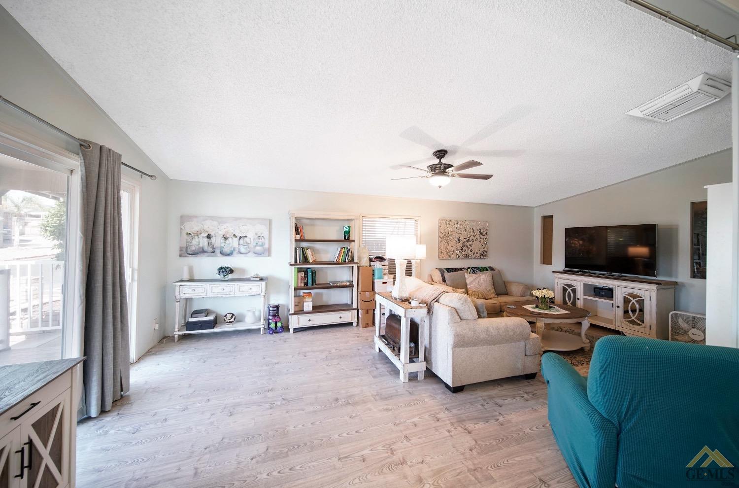 Undisclosed Address Bakersfield, CA 93308 - Photo 4 of 25 a living room with furniture and a flat screen tv