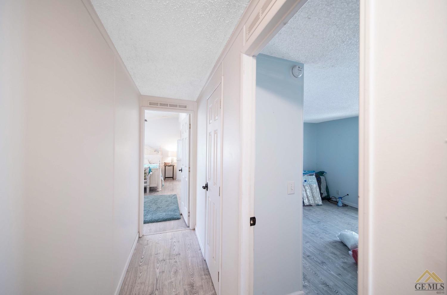 Undisclosed Address Bakersfield, CA 93308 - Photo 7 of 25 a view of a hallway with wooden shelves