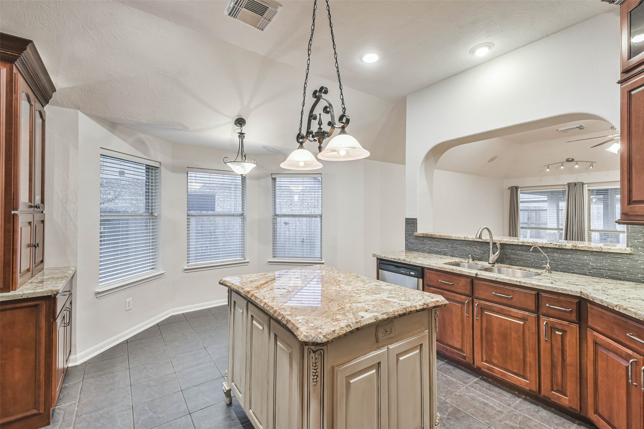 20942 Wind Field Lane Spring, TX 77379 - Photo 20 of 46 a kitchen with center island table and chairs