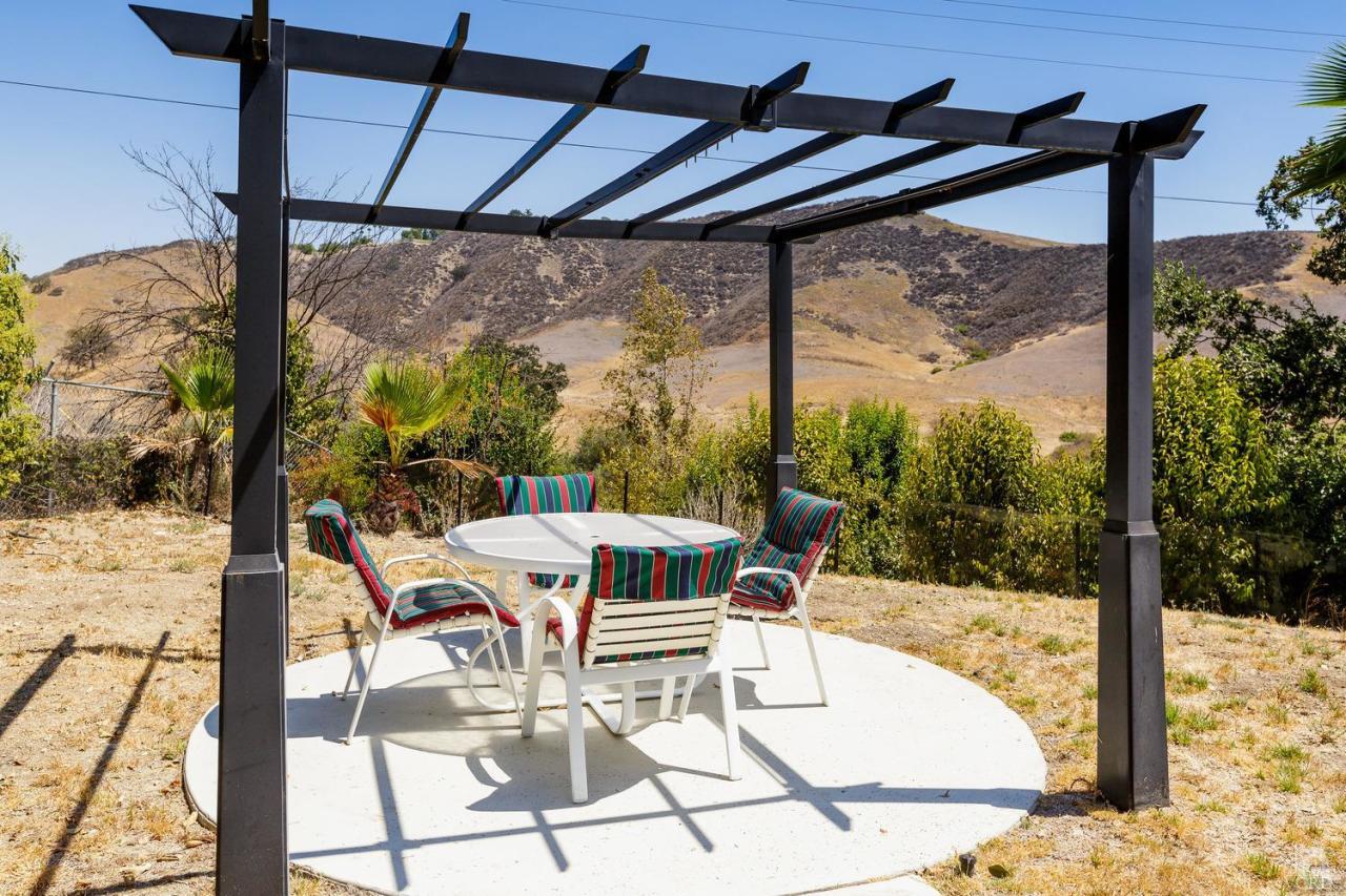 5534 Parkmor Road Calabasas, CA 91302 - Photo 29 of 29 a view of a patio with a table chairs and wooden floor