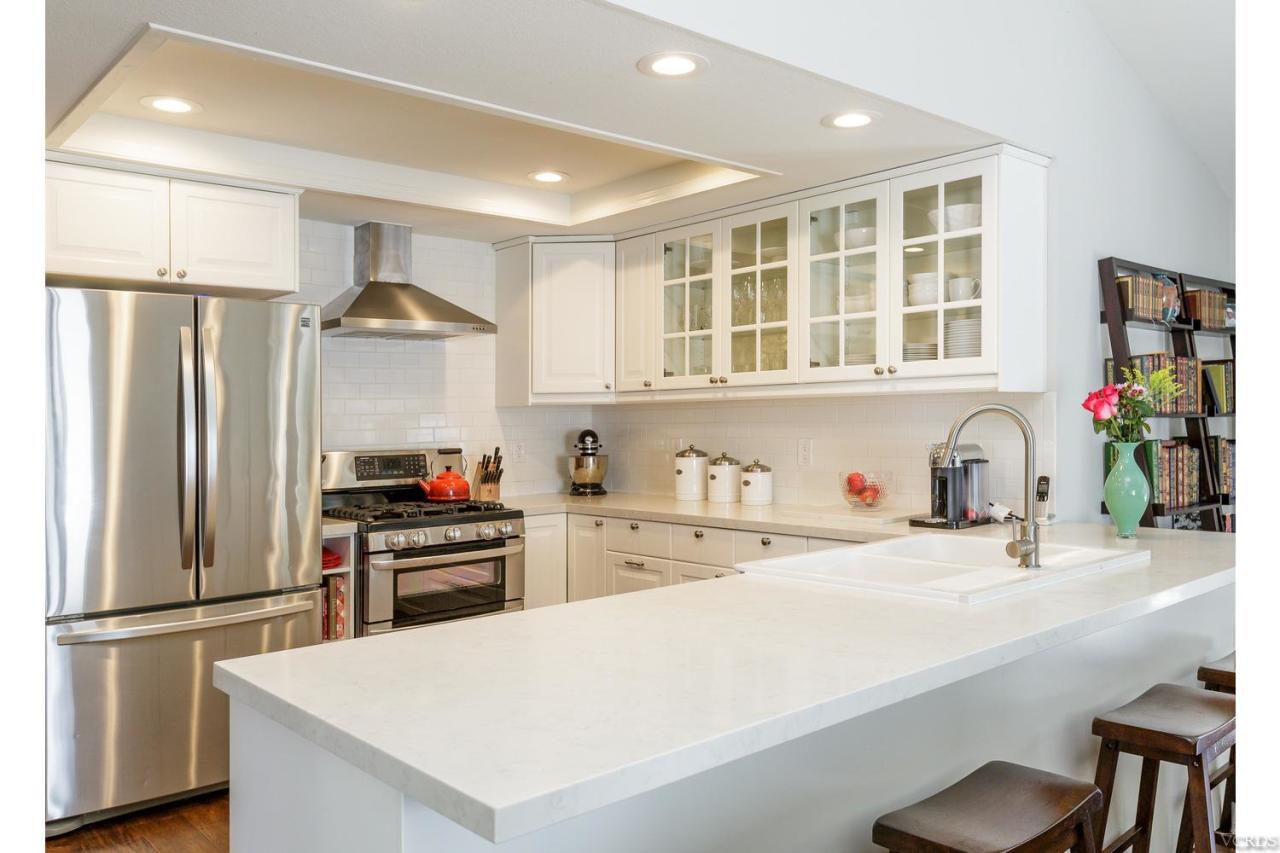 5534 Parkmor Road Calabasas, CA 91302 - Photo 6 of 29 a kitchen with stainless steel appliances a refrigerator sink and cabinets