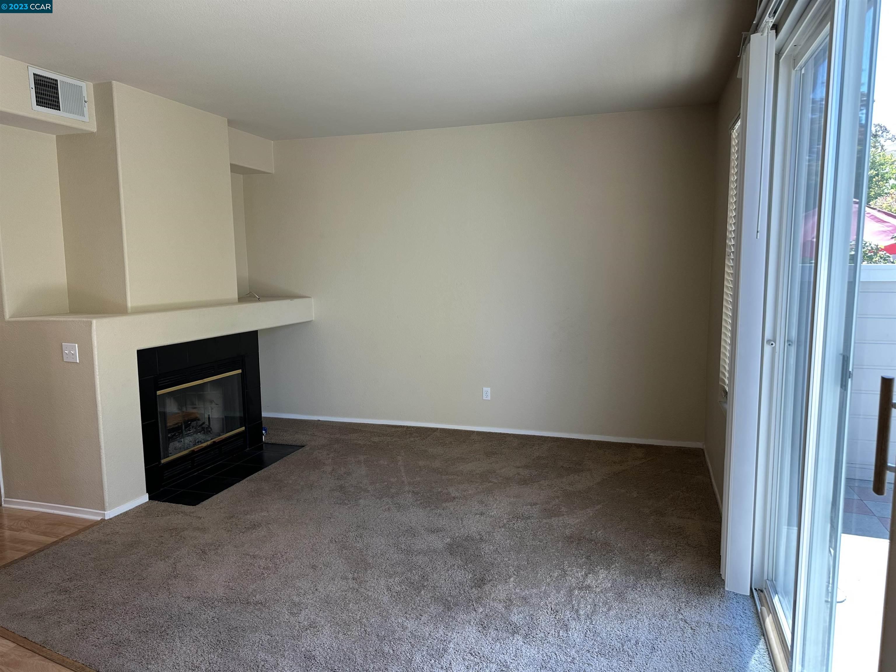 3505 Coyote Circle Clayton, CA 94517 - Photo 3 of 16 a view of an empty room with a fireplace and a window