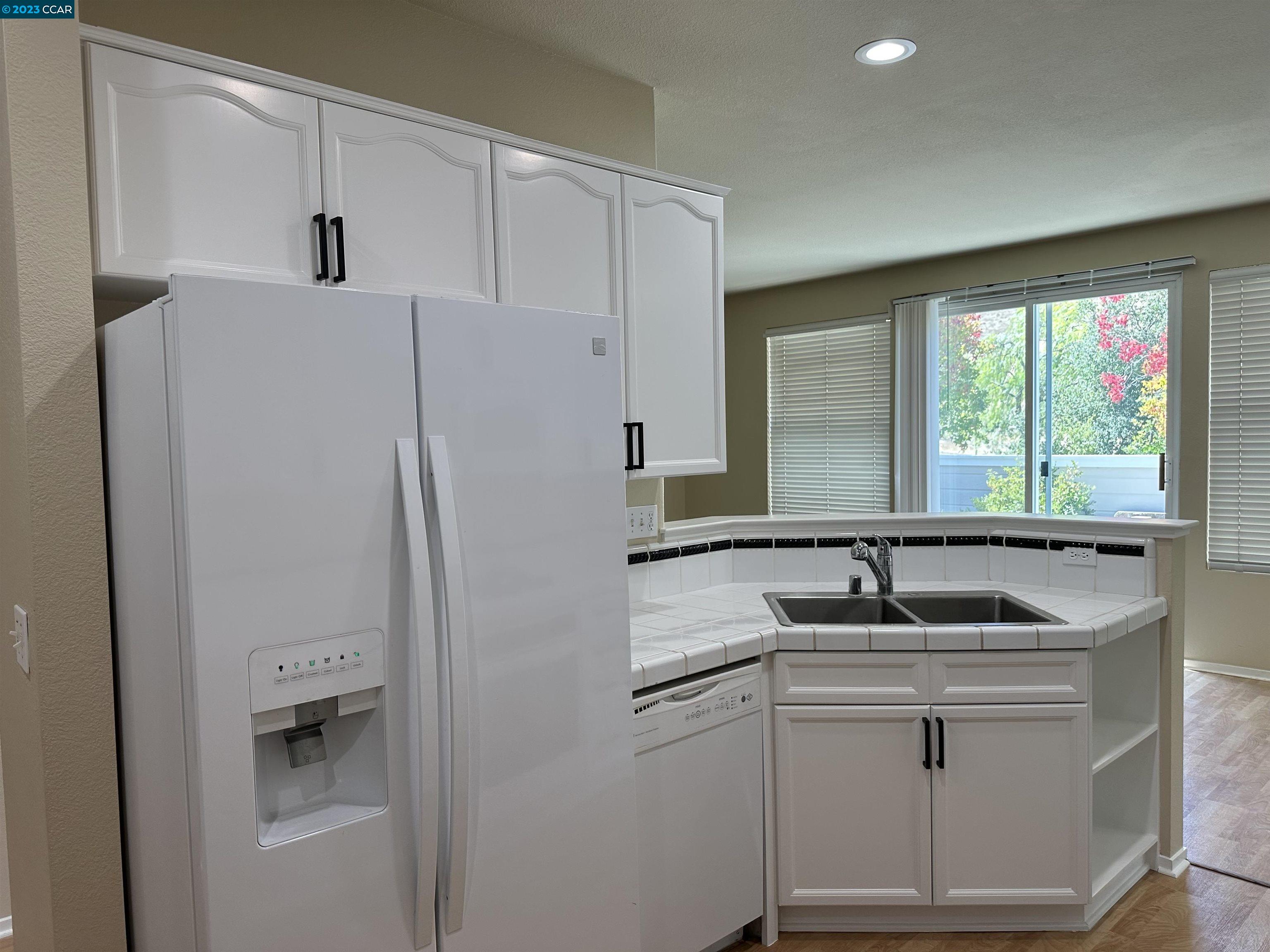 3505 Coyote Circle Clayton, CA 94517 - Photo 6 of 16 a kitchen with white cabinets and a sink